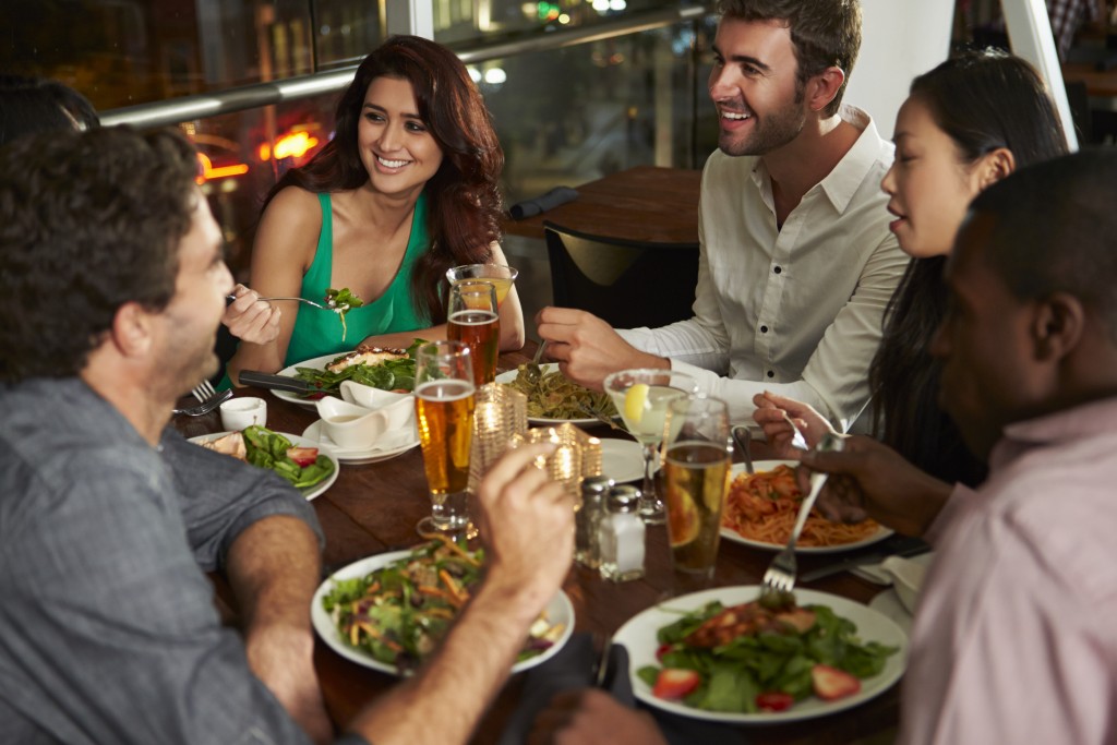 Group Of Friends Enjoying Evening Meal In Restaurant