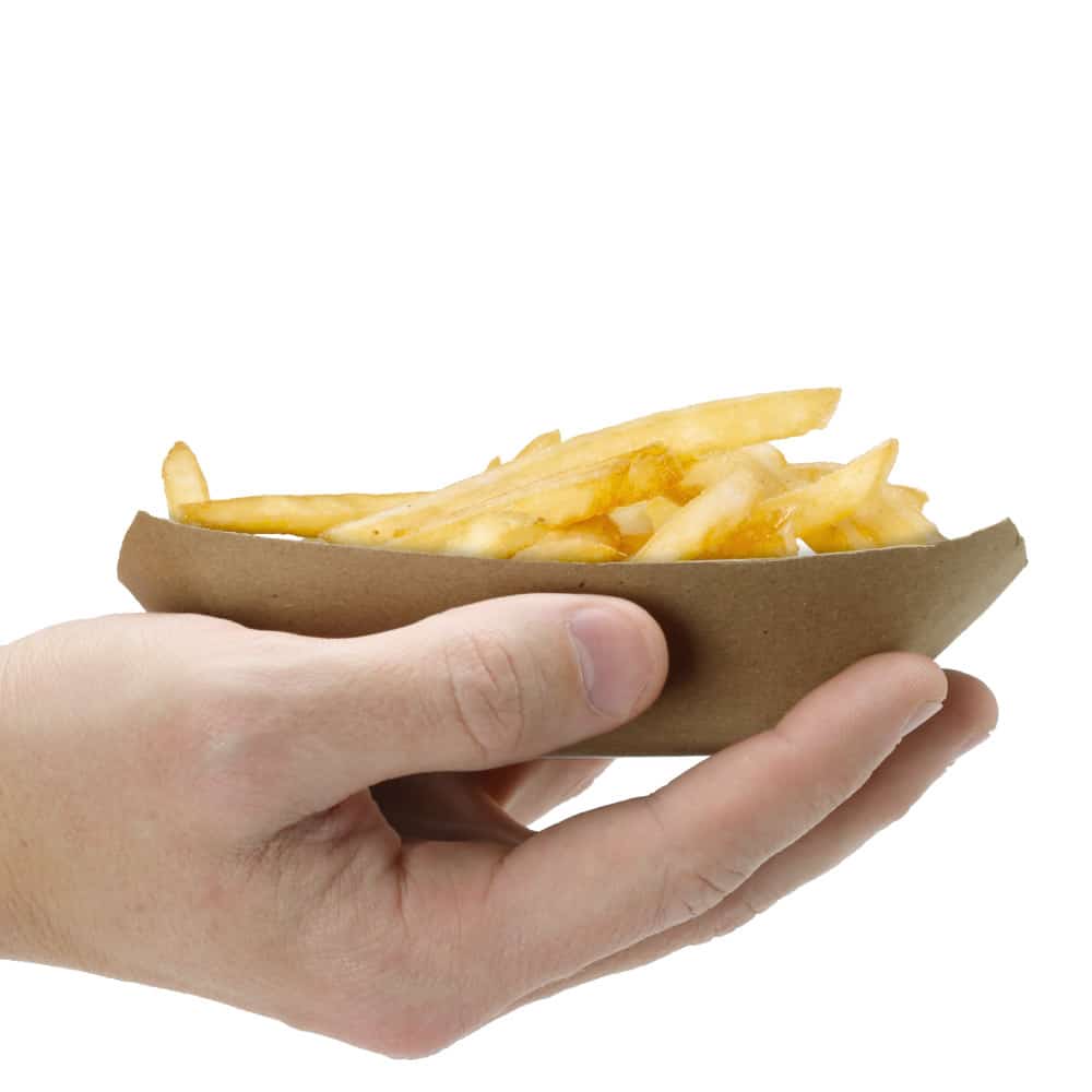 hand holding kraft paper food tray with fries